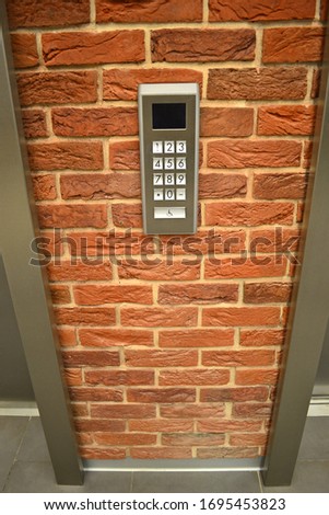 elevator buttons on a brick wall