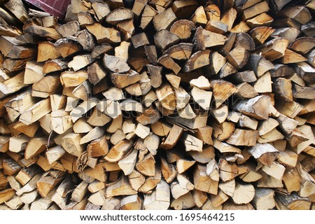 logs lie on top of each other for heating in a home oven. Background of firewood Royalty-Free Stock Photo #1695464215
