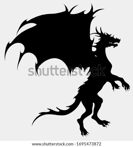 Dragon preparing for takeoff. Silhouette of a winged snake, mythological character of fairy tales. Fantastic creature growls.