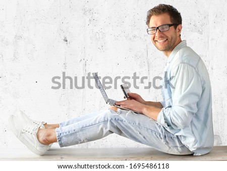 Young man with a laptop and a credit card