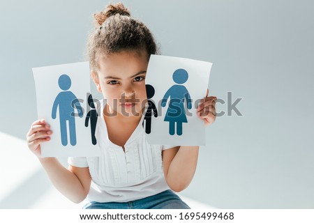african american child holding ripped paper with family on white, divorce concept