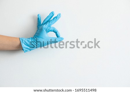 Blue medical gloves on the white background. Rules of the coronavirus pandemic