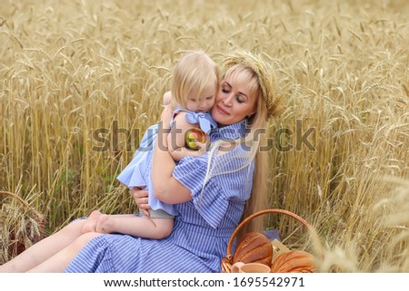 mother and daughter in a wheat field