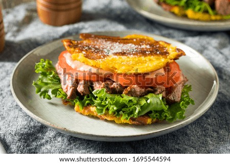 Homemade Puerto Rican Jibarito Steak Sandwich with Lettuce and Tomato
