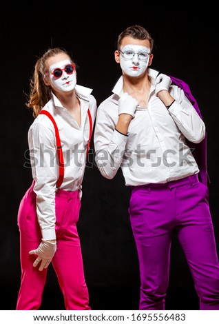 Portrait of male mime artists, isolated on black background. Two man are posing for camera. Symbol of friendship, lovers, tolerance, LGBT