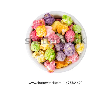 Sweet multicolor caramel Popcorn in white bowl. Studio Photo