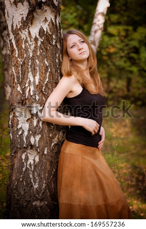 Girl standing near a tree