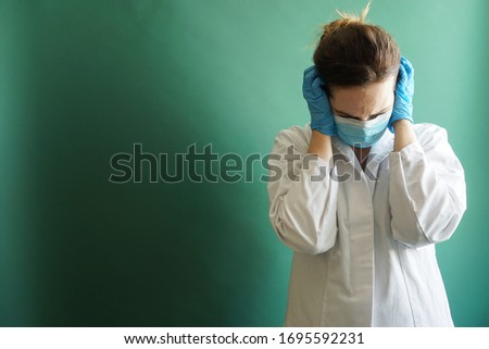 Polish nurse making a helpless gesture on a green background.