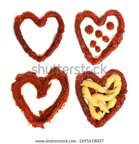Pictures made from ketchup on white background. Hearts from Ketchup. Sauce