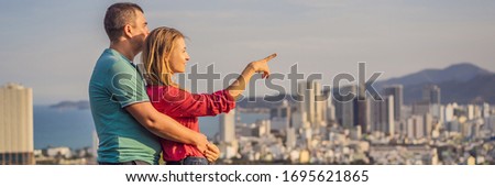 Happy couple tourists on the background of Nha Trang city. Travel to Vietnam Concept BANNER, LONG FORMAT