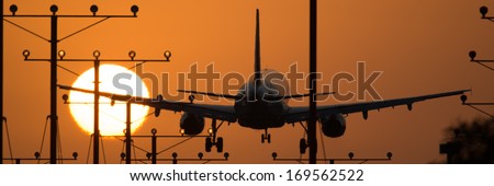 Airplane landing at Los Angeles International Airport during sunset, Los Angeles, California, USA