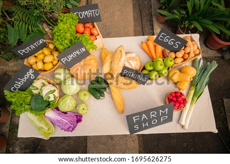Above view of various assortment of fruits, vegetables and bread for selling at farm shop