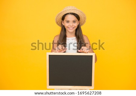 announcement and info. tropical elegant girl with board. copy space. happy girl in straw hat on yellow background. Accessories of romantic girl traveler. retro kid express surprise. Cute and stylish.