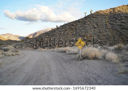 A funny sign indicating a rough road ahead on a dirt road outside of Death Valley.                     