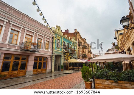Street with outdoor cafe tents in old town Tbilisi. Georgia. Royalty-Free Stock Photo #1695687844