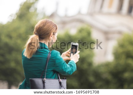 young woman taking a selfie on her phone