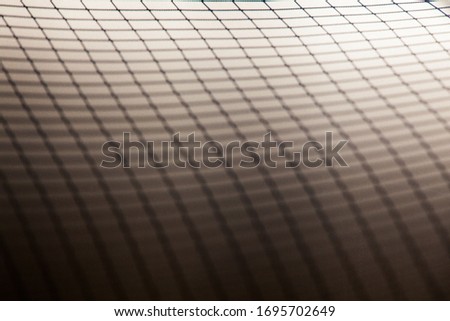 Grid reflection on a white and gray background.