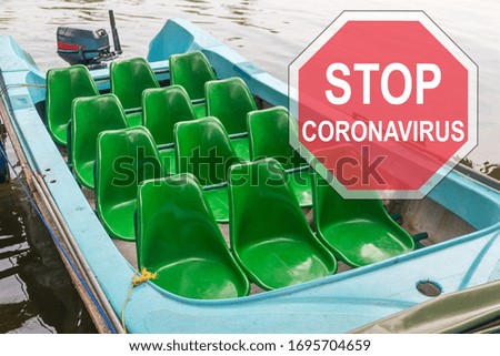 ''Stop coronavirus'' road sign against an empty motorboat