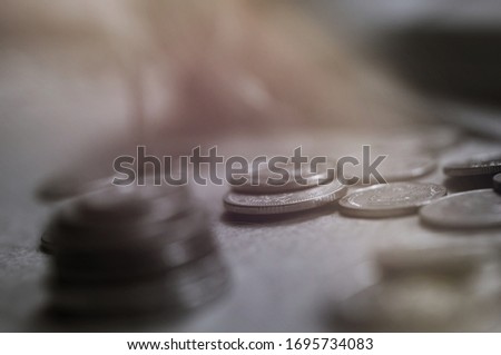 The close-up group of a Thai coins placed on the floor selective focus and shallow depth of field. BW color tone.