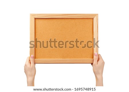 Female hands holding photo frame with copy space isolated on white