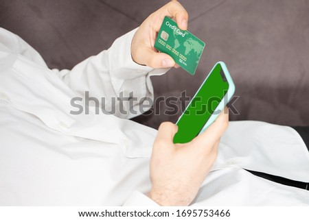 using cell phone holding a credit card and for online shopping. commerce concept and online buy