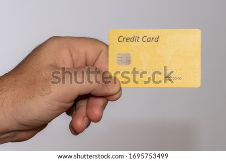 Hand holding blank credit card isolated on white