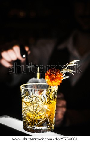 Shots of alcoholic drink on dark background. Herbal bitter liquor with different natural ingredients