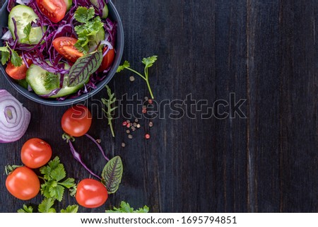 Large colorful group of vegetable and fruits on a dark wooden background with copy space, top view, selective focus, flat lay. Healthy eating concept.