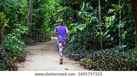 Woman running on trail at "Bosque da Freguesia" (Freguesia Forest Public Park)                              