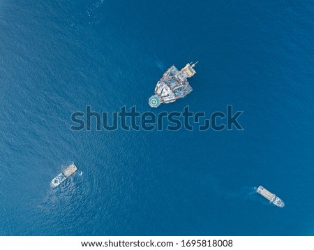 Aerial view offshore jack up rig and a tow vessel at the offshore location