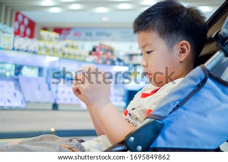 boy playing mobile phone, kid use smartphone, addicted game and cartoon, child watching cartoon
