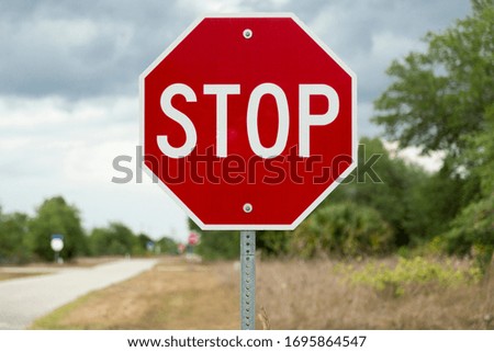 Stop sign on road (USA/North American road sign)