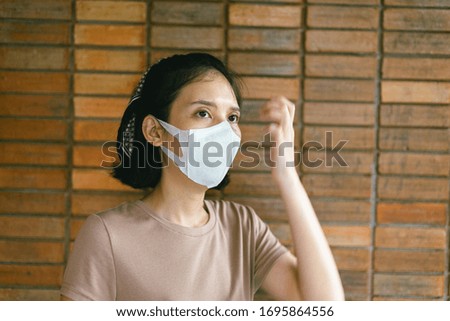 The image face of a young  female wearing a mask to prevent germs, toxic fumes, and dust. Prevention of bacterial infection Corona virus or Covid 19 in the blur background