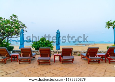 chair pool or bed pool and umbrella around swimming pool with sea beach background
