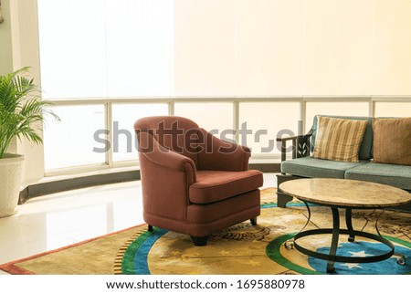 empty sofa and chair with pillows decoration in a room