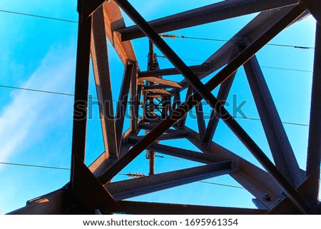 Power lines and electric towers on a background of blue sky.