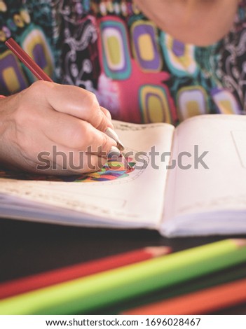 Close up woman coloring mandala. Stay at home. 