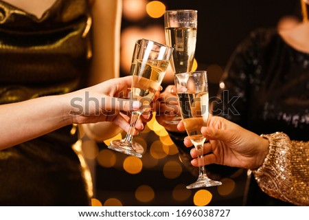 Women clinking glasses of tasty champagne at party Royalty-Free Stock Photo #1696038727