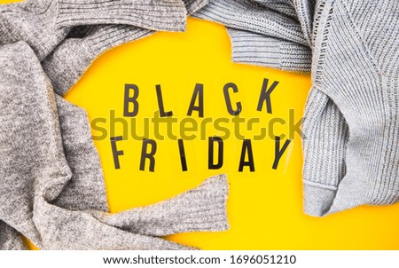 word black friday on yellow background , shopping sale concept, Flat lay design of Black Friday Sale text, Online shopping concept, advertising for seasonal promotion, sweater