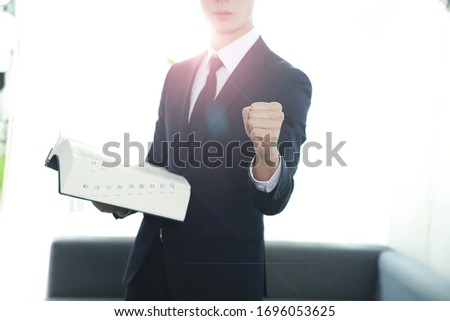 Lawyer showing fist with law book