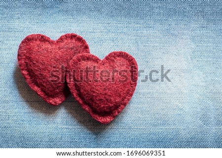 valentines day background, two soft hearts on a denim background,  concept of a couple in love,