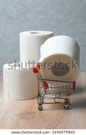 Toilet paper in a supermarket cart. The concept of buying toilet paper.