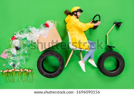 Full body high angle above flat lay photo of irresponsible lady sorting trash drive recycle losing garbage paper box plastic products falling on fresh flowers isolated green color background Royalty-Free Stock Photo #1696090156