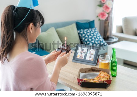 Asian woman virtual happy hour meeting birthday party with cake online together with her friend in video conference with digital tablet for a online meeting in video call for social distancing