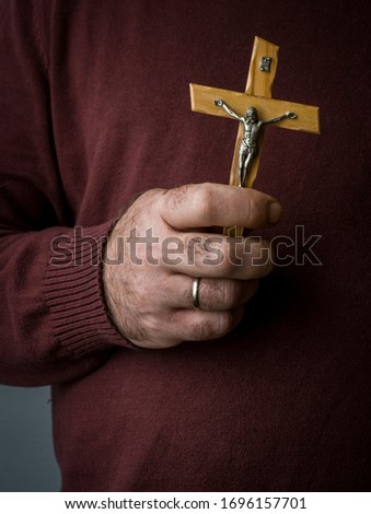 Wooden catholic cross in male hand