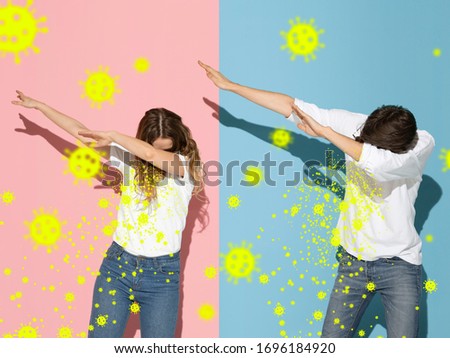 How to sneezing right - caucasian couple dabbing isolated on studio background with viruses illustration. Beautiful models. Human emotions, sales, healthcare and medicine concept. Stop epidemic.