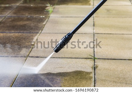 Detail of cleaning terrace with high-pressure water blaster Royalty-Free Stock Photo #1696190872