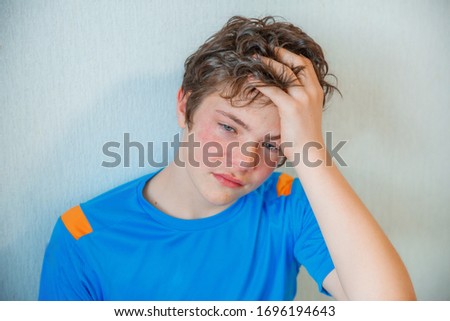 teen boy crying at home, crying Royalty-Free Stock Photo #1696194643