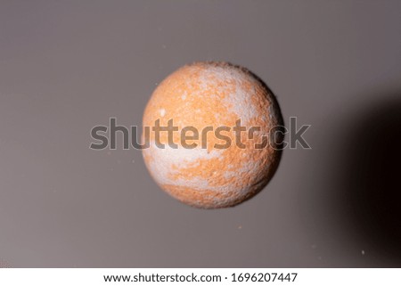 Orange balloon, bath salt on a gray background.
