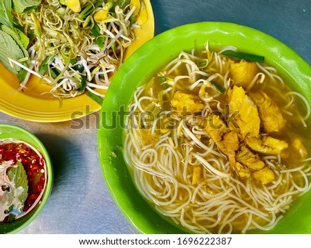 Vietnamese bun ca loc snake head fish noodle rice soup bowl and vegetable